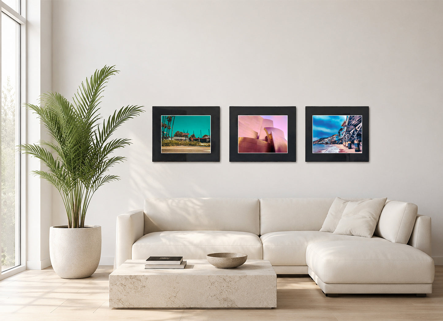 Three framed fine art photography prints displayed as a triptych gallery wall above a sofa with plant.