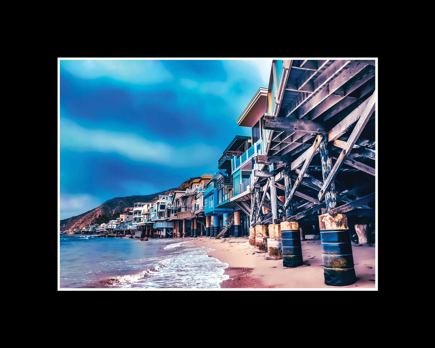 Photo of Malibu beachfront houses lined up along the California coast