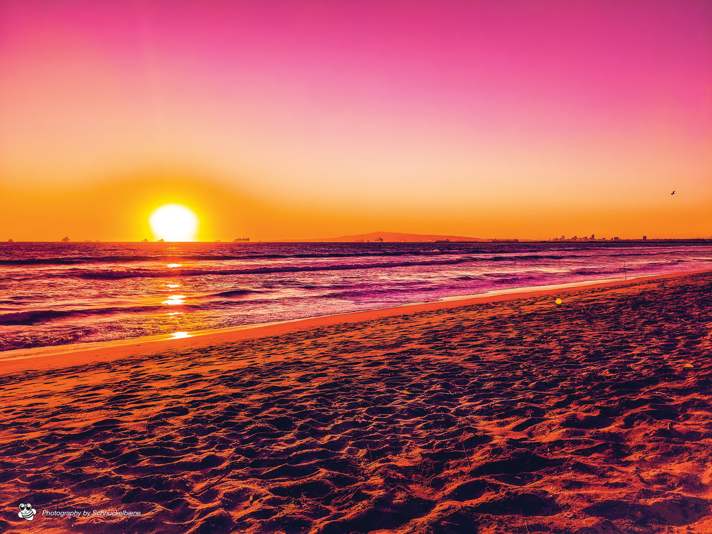 Pink sunset over Sunset Beach in Orange County, California with dreamy light