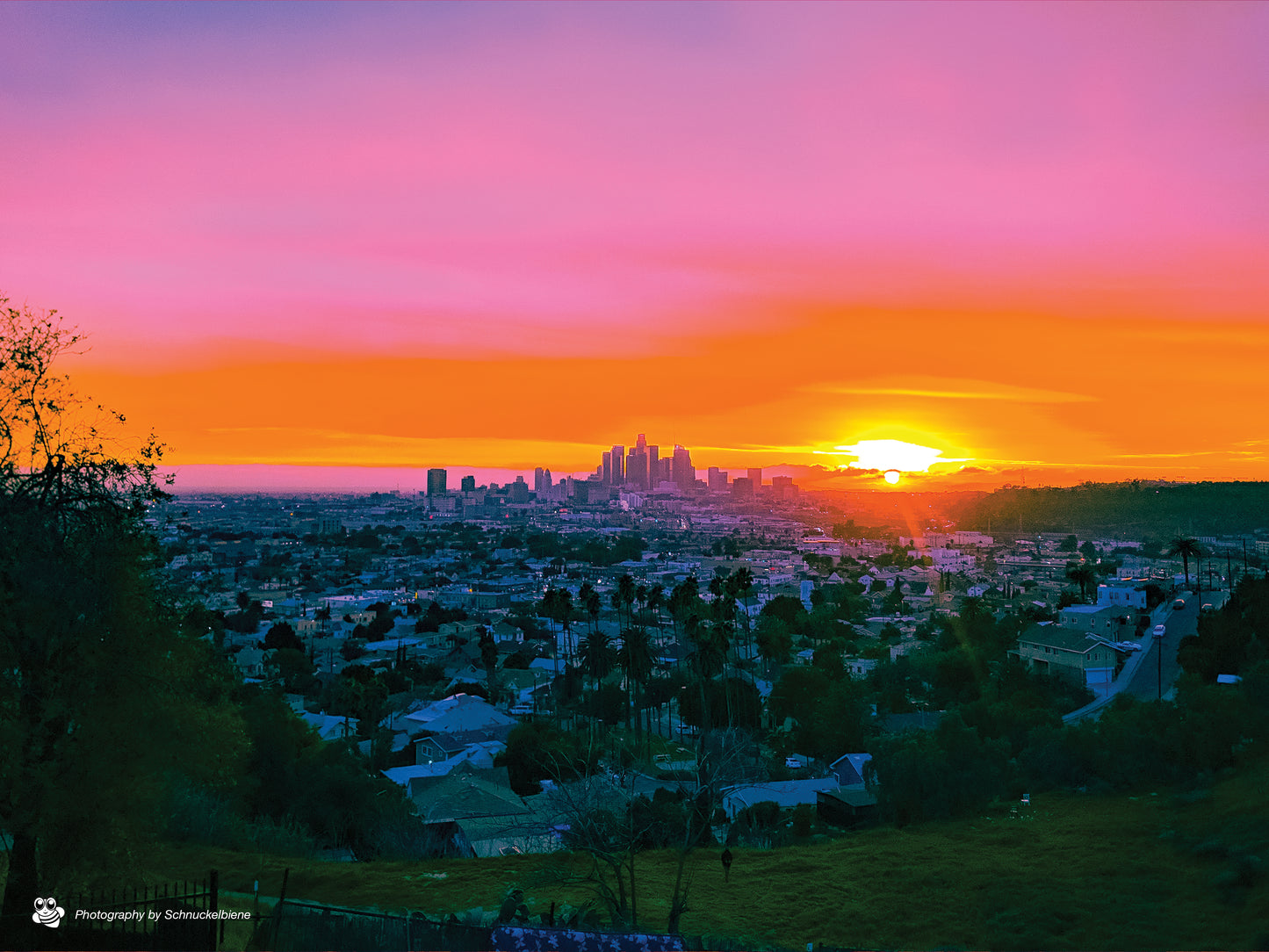 Sunset over Downtown Los Angeles skyline with glowing pastel sky