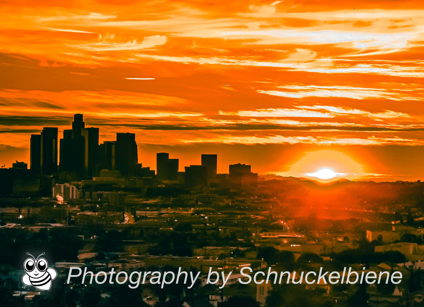 Downtown Los Angeles skyline glowing at sunset with warm golden light