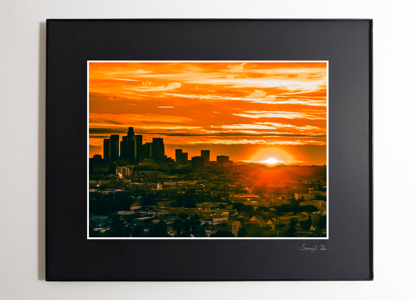 Downtown Los Angeles skyline glowing at sunset with warm golden light