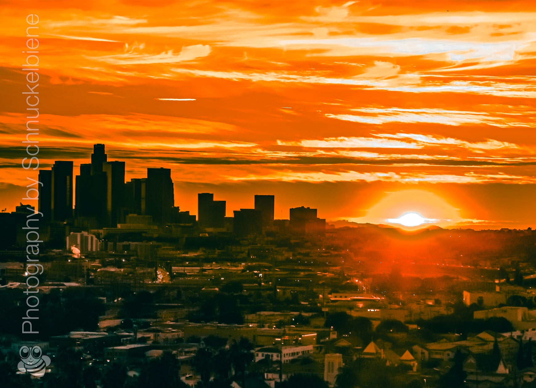 Downtown Los Angeles skyline glowing at sunset with warm golden light