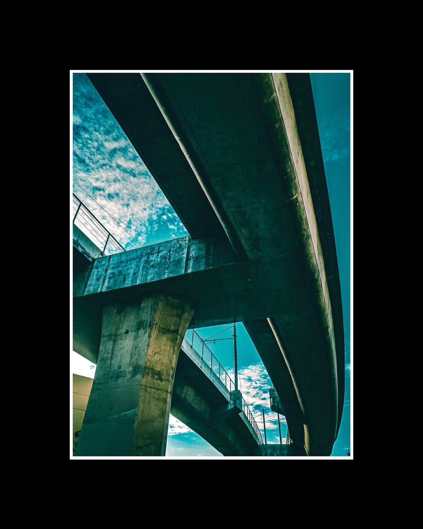 Fine art photo of a purple-lit freeway bridge in Downtown Los Angeles at night, showcasing urban architecture and city atmosphere.