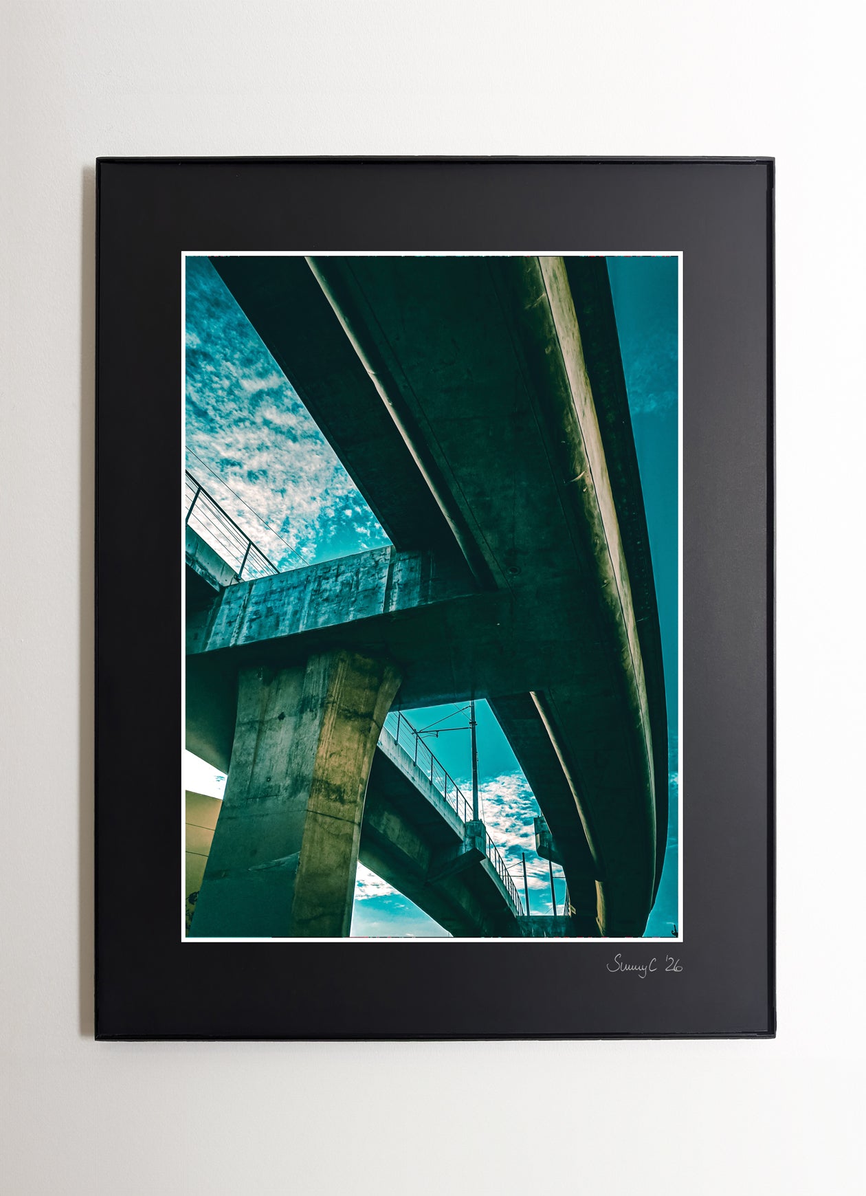 Fine art photo of a turquoise-lit freeway bridge in Downtown Los Angeles at night, showcasing urban architecture and city atmosphere