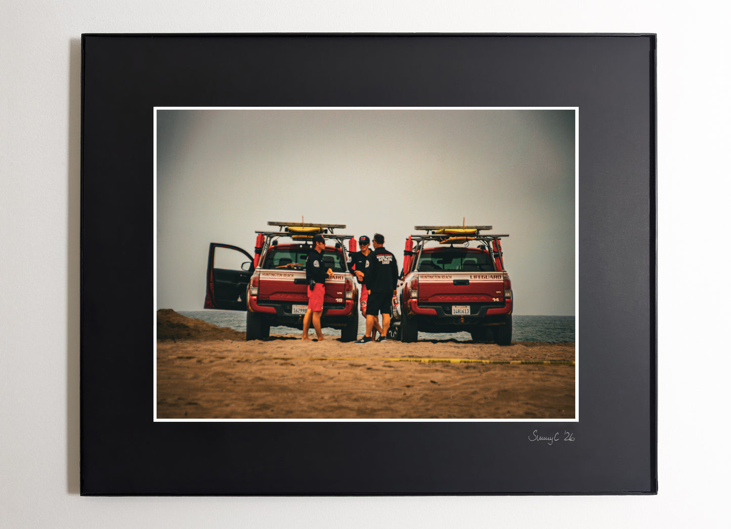 Photo of Huntington Beach lifeguards with jeeps on a cloudy day at the beach