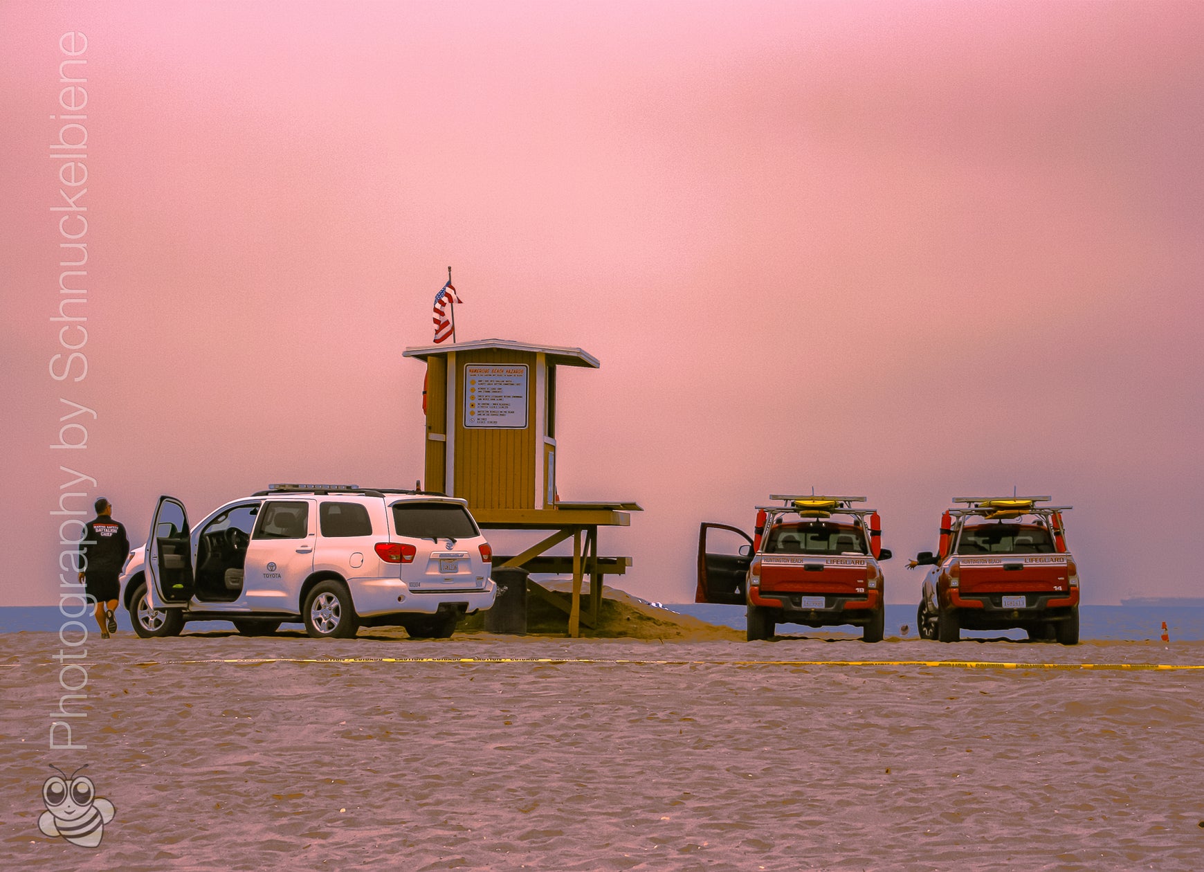Huntington Beach lifeguard tower reunion under pink cloudy sky