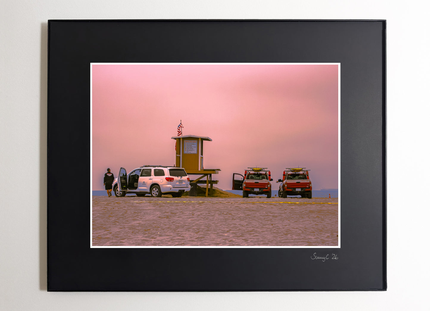 Huntington Beach lifeguard tower reunion under pink cloudy sky