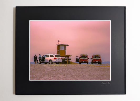 Huntington Beach lifeguard tower reunion under pink cloudy sky