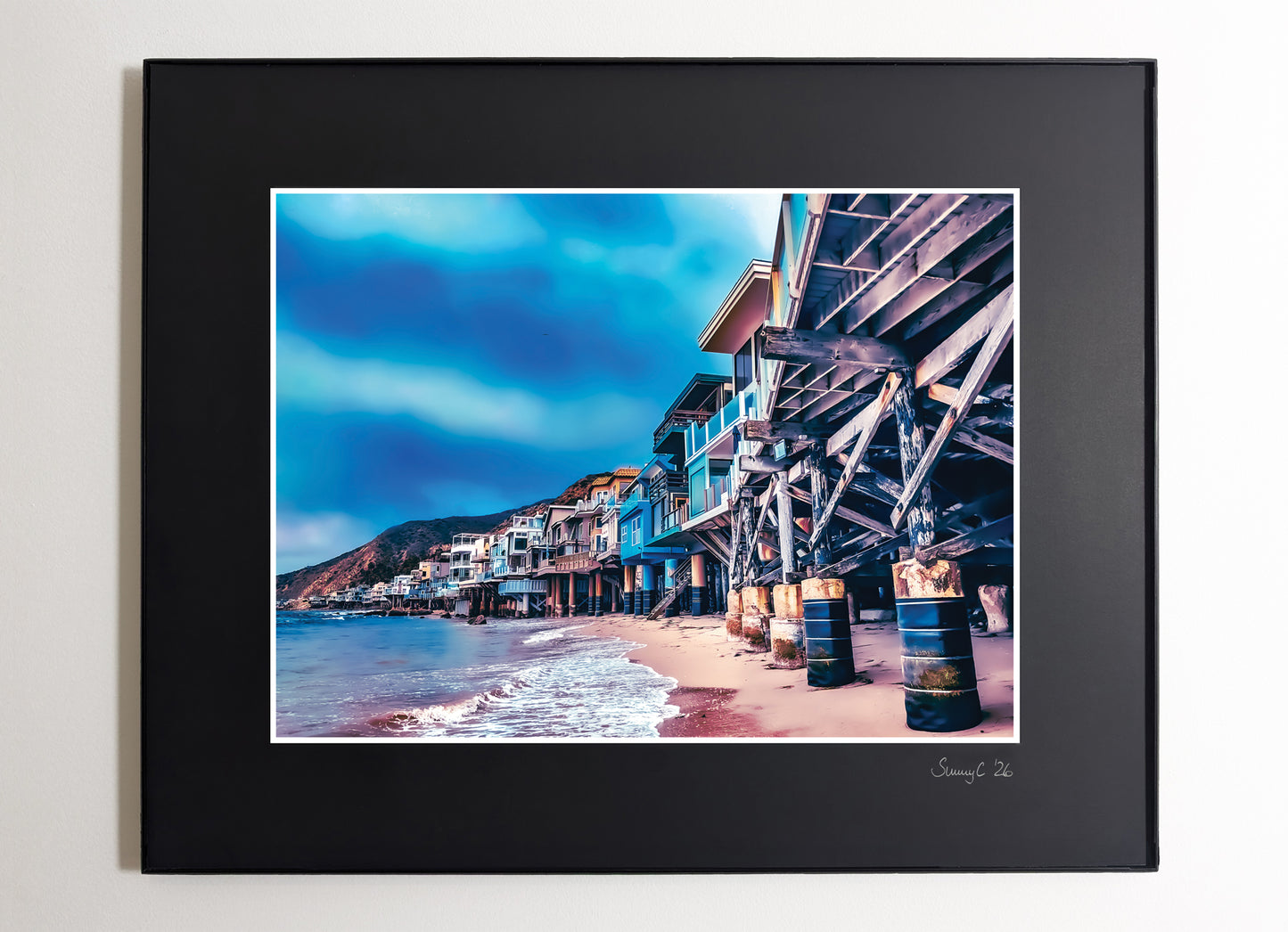 Photo of Malibu beachfront houses lined up along the California coast