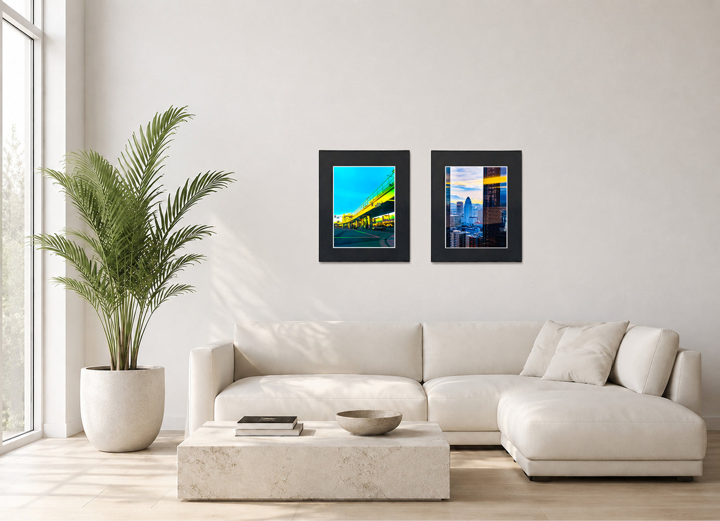 Two framed fine art photography prints displayed as a diptych gallery wall above a sofa with plant.