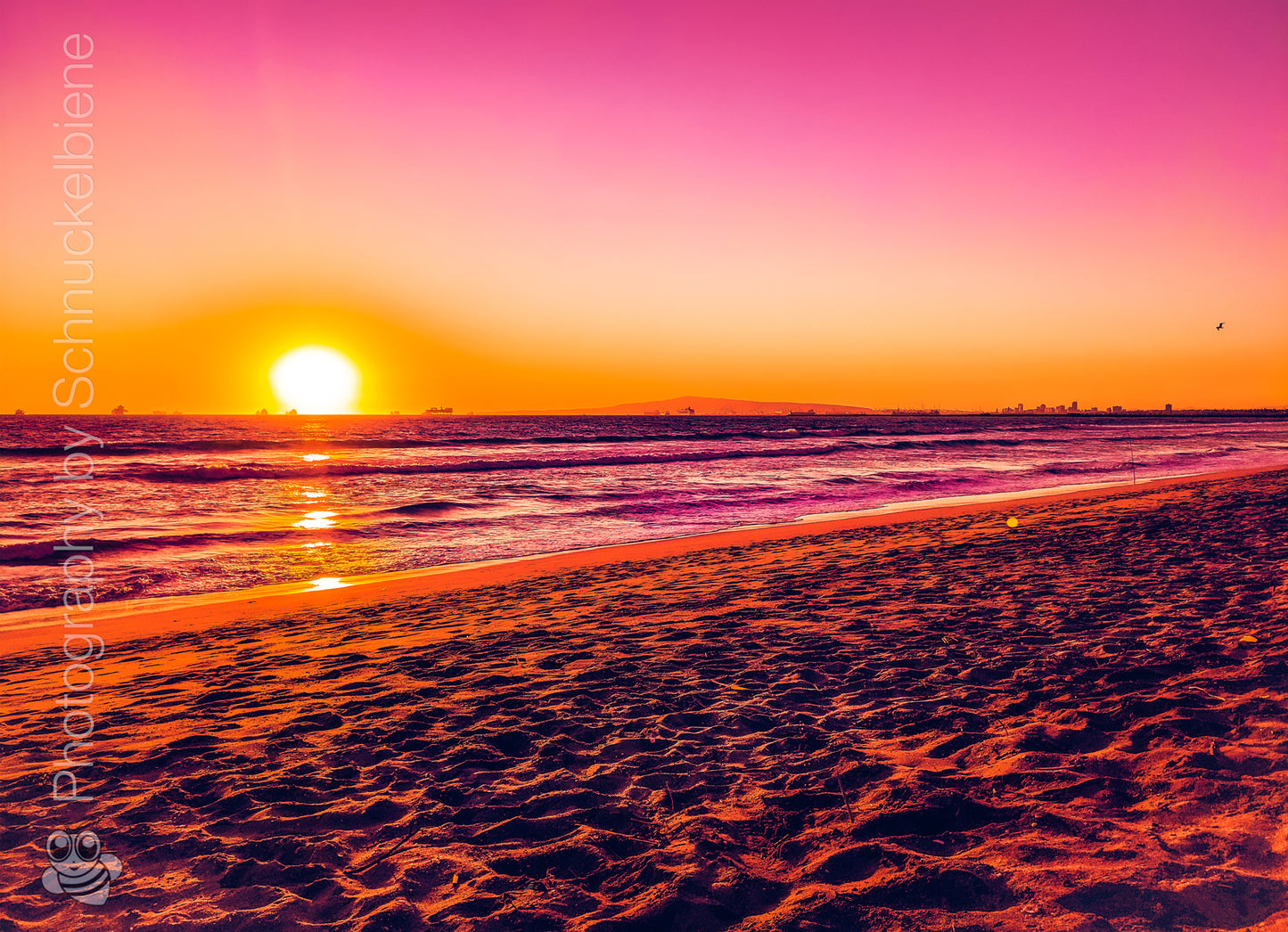 Pink sunset over Sunset Beach in Orange County, California with dreamy light