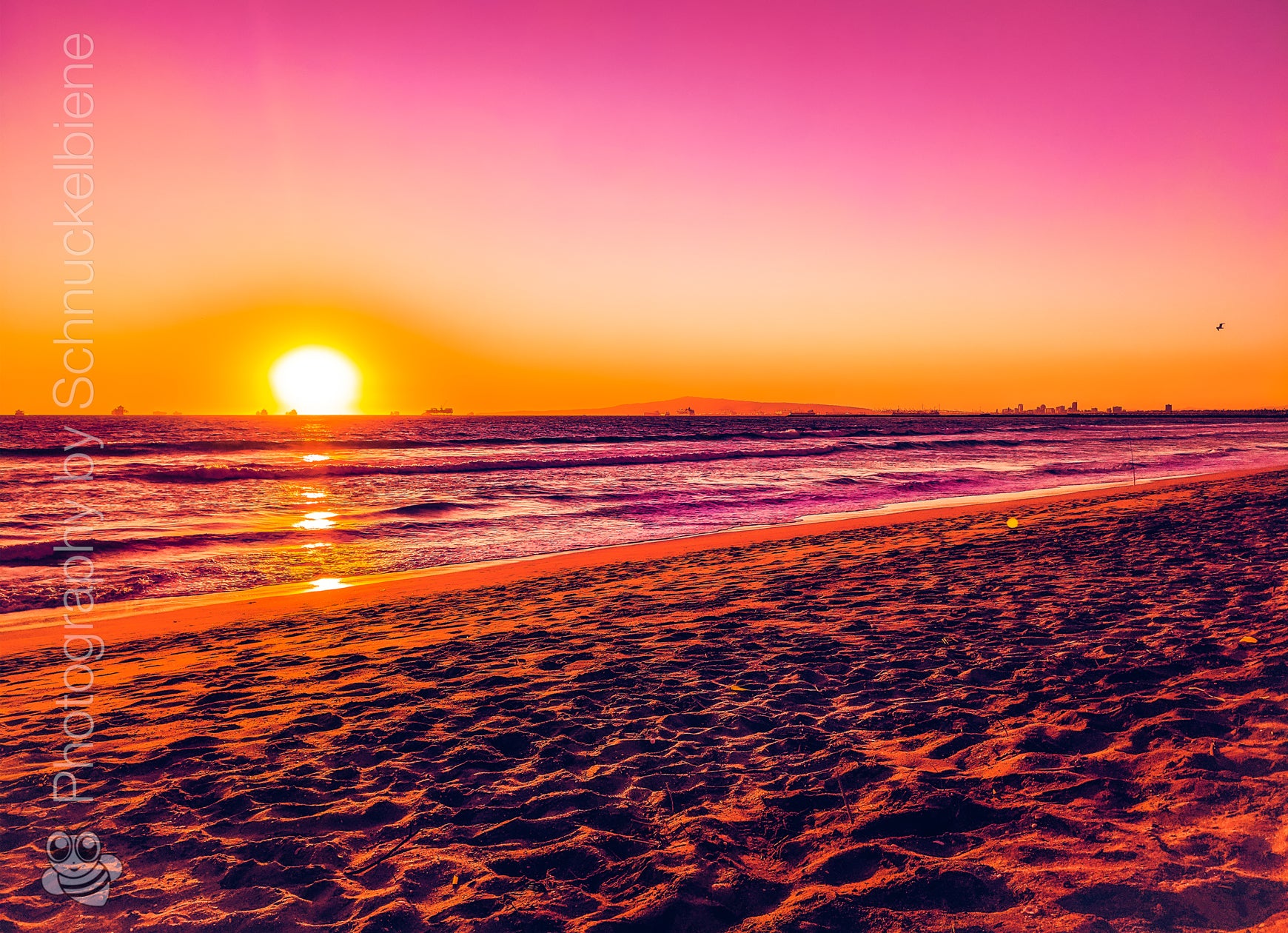 Pink sunset over Sunset Beach in Orange County, California with dreamy light