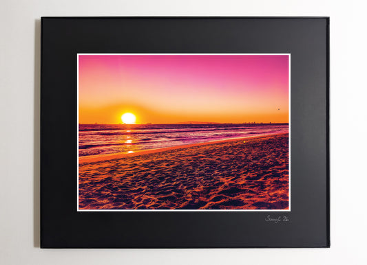 Pink sunset over Sunset Beach in Orange County, California with dreamy light