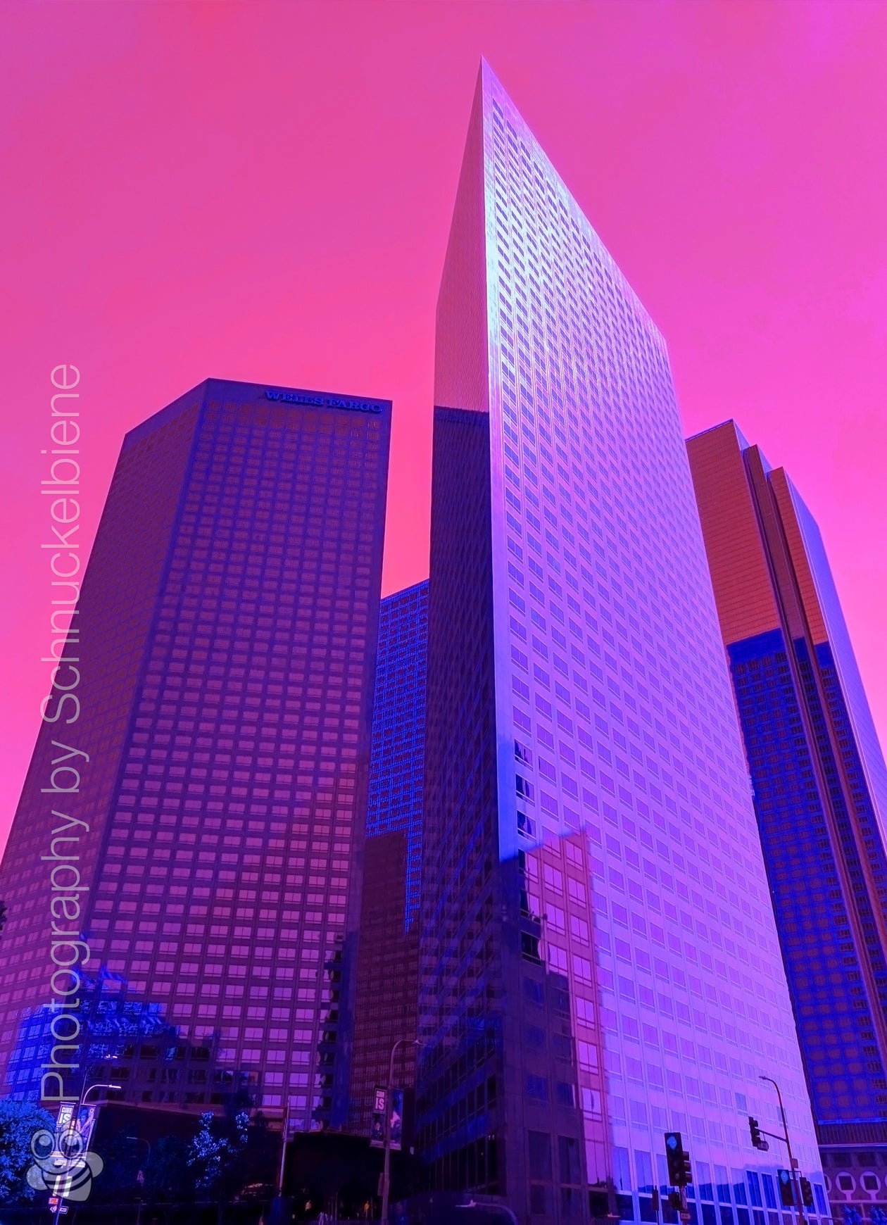 Framed fine art print of vibrant purple skyscrapers and a pink sky in downtown Los Angeles, showcasing a bold urban scene