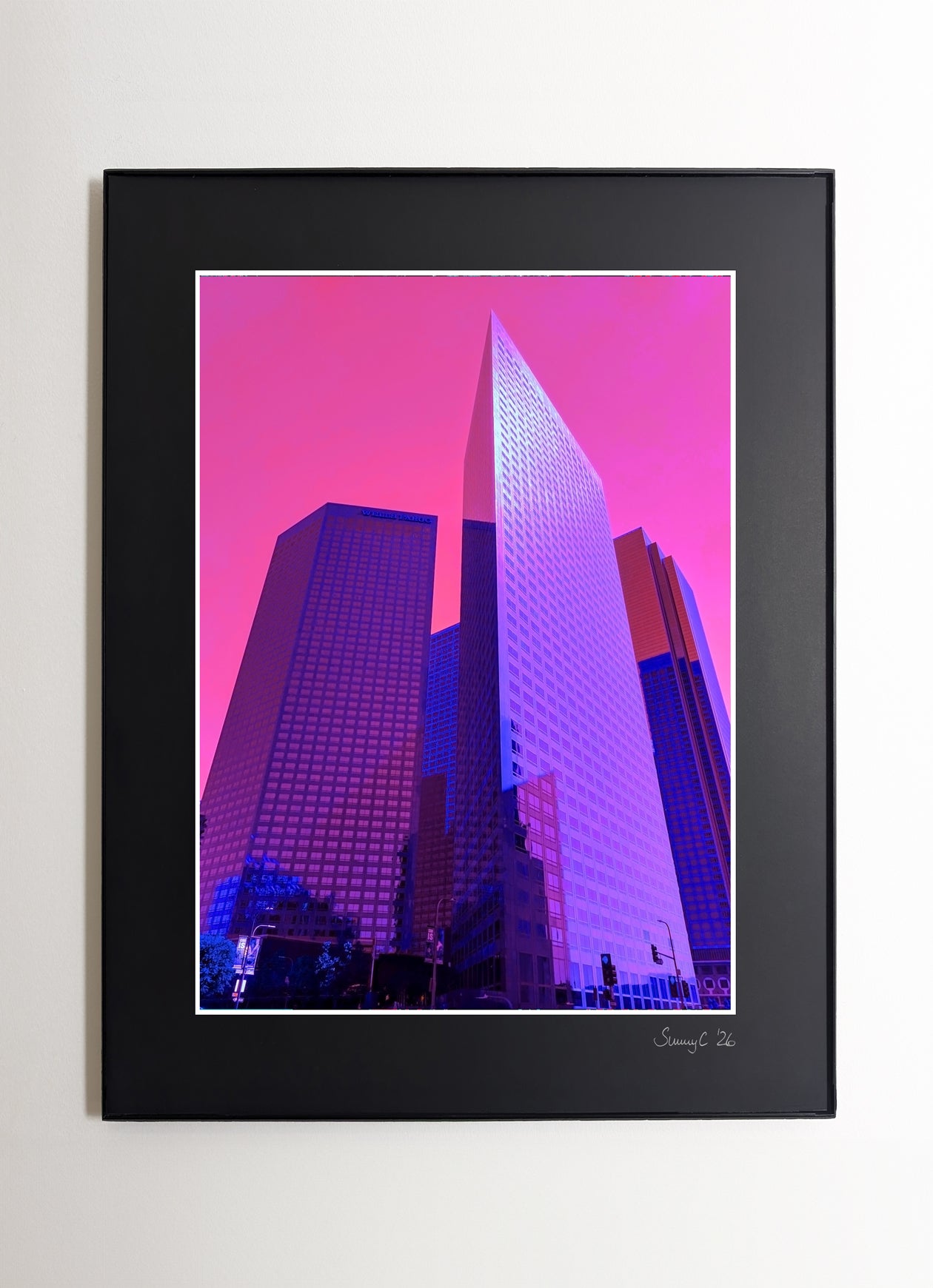 Framed fine art print of vibrant purple skyscrapers and a pink sky in downtown Los Angeles, showcasing a bold urban scene
