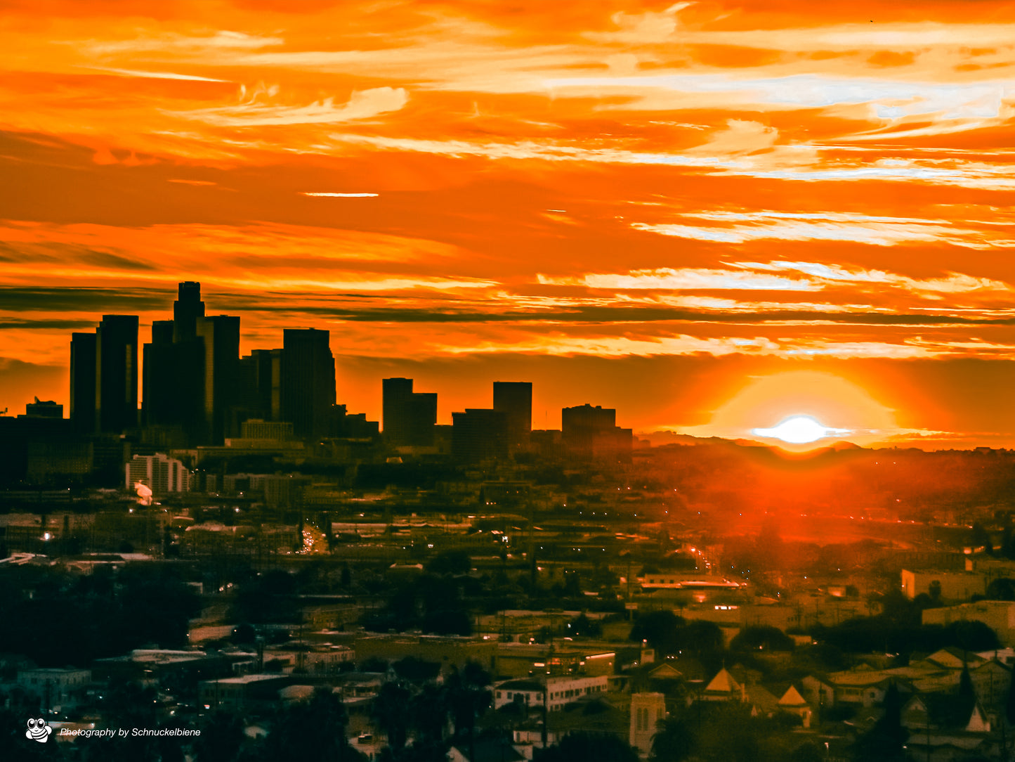 Downtown Los Angeles skyline glowing at sunset with warm golden light
