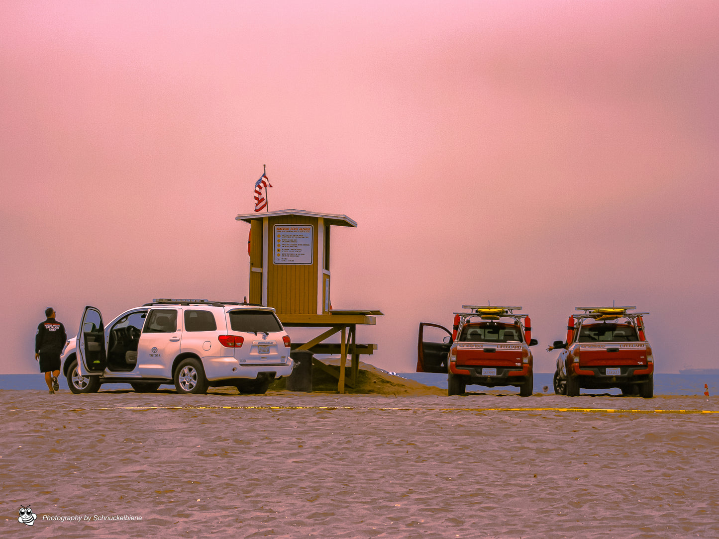 Huntington Beach lifeguard tower under pink cloudy sky