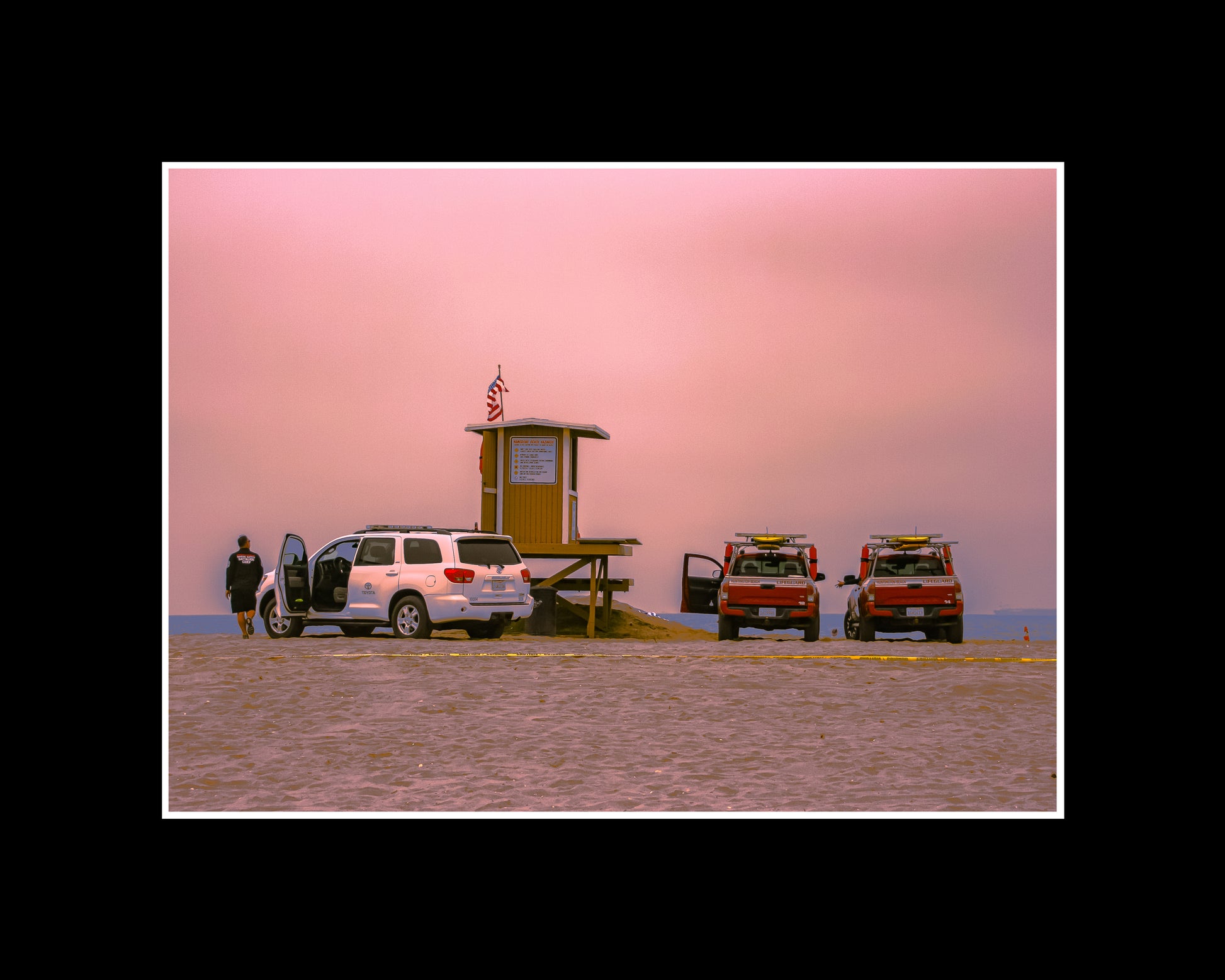 Huntington Beach lifeguard tower under pink cloudy sky