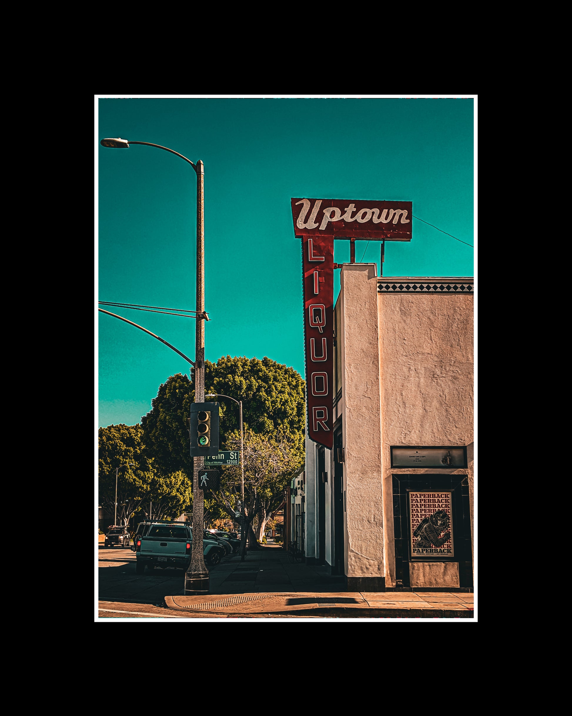 Framed photo print of the Uptown Whittier Liquor Shop with retro typography and bold colors