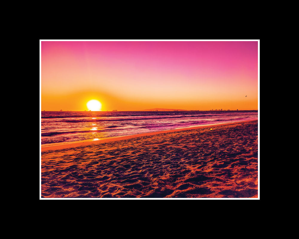 Pink sunset over Sunset Beach in Orange County, California with dreamy light