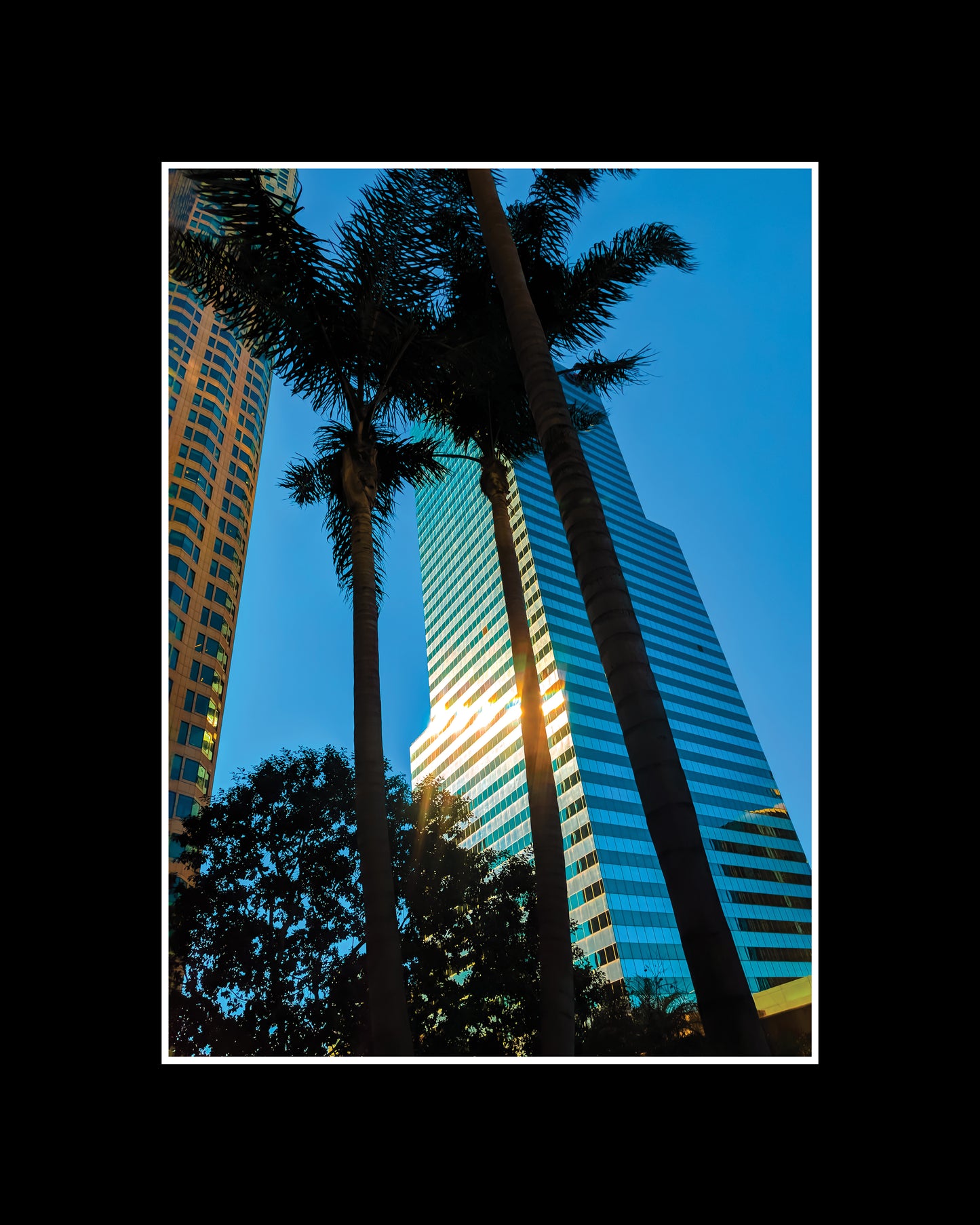 Framed photo print of the US Bank Tower in downtown Los Angeles at sunrise, with a golden glow and reflection of pastel skies