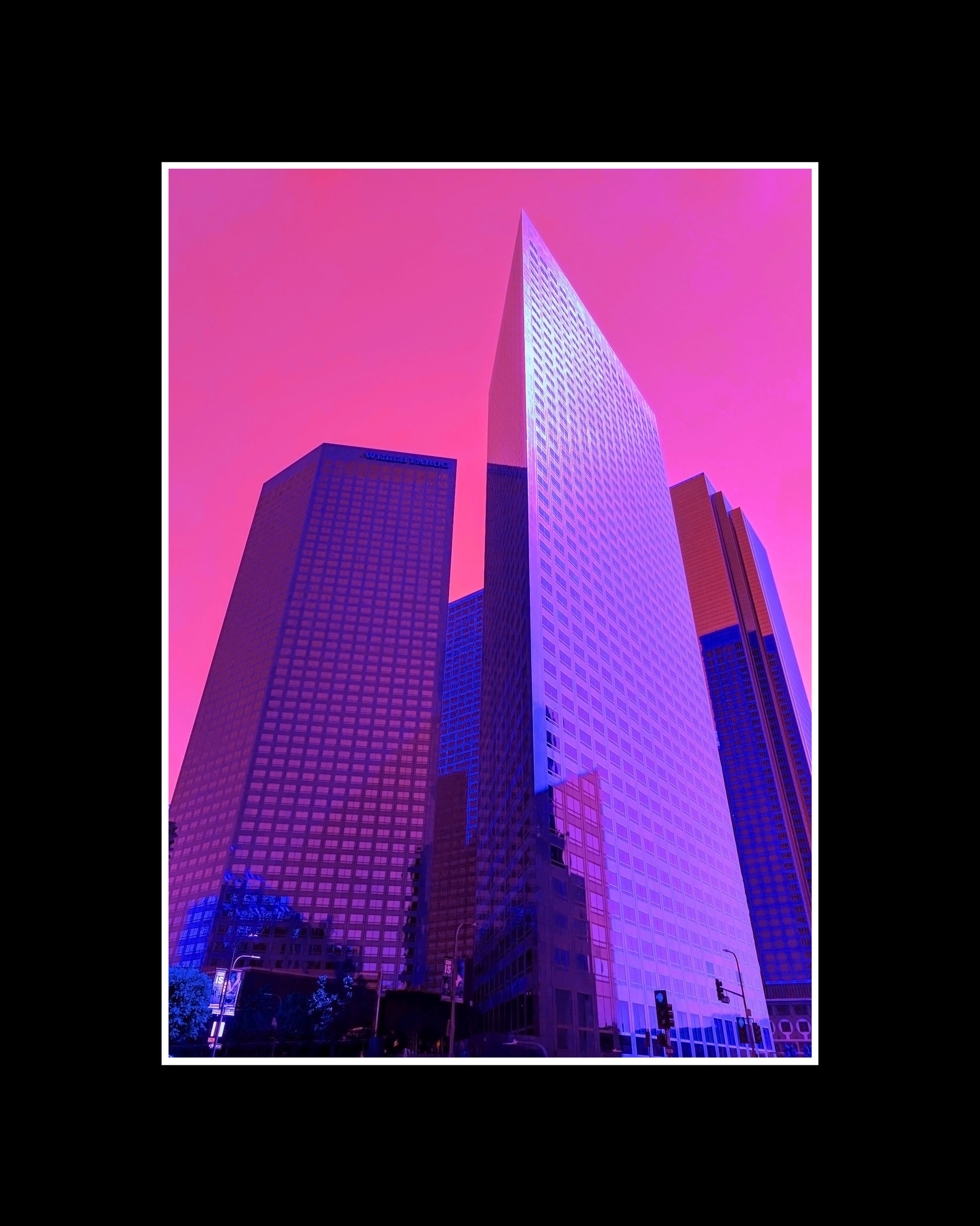 Framed fine art print of vibrant purple skyscrapers and a pink sky in downtown Los Angeles, showcasing a bold urban scene